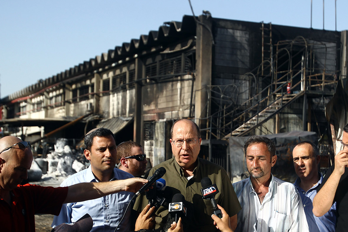 30 June: Israeli defence minister Moshe Yaalon answers journalists' questions as he visits a factory in Sderot that was damaged by a rocket fired from Gaza