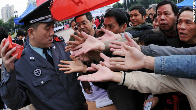 A group of Chinese men gather to collect the free condoms distributed to mark the World's AIDS Day in Fujian province on December 1, 2010. 