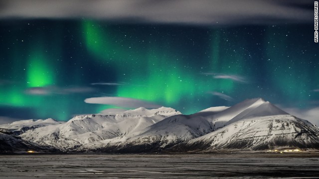 <strong>March 9:</strong> The Northern Lights appear over snow-covered mountains in Iceland.