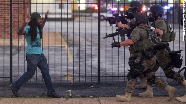 <strong>August 11:</strong> Police wearing riot gear confront a man during <a href='http://ift.tt/1oN7VcH'>protests in Ferguson, Missouri.</a> Some protests in the city turned into clashes between angry citizens and police after Michael Brown, an unarmed black teenager, was killed by Darren Wilson, a white police officer, on August 9.