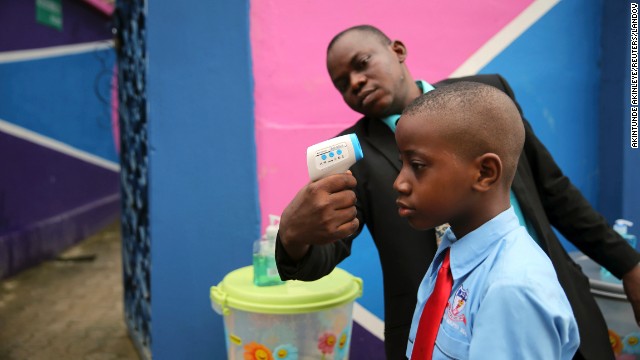 <strong>September 22:</strong> Amid the Ebola scare in West Africa, a school official in Lagos, Nigeria, takes a student's temperature with an infrared laser thermometer. Health officials say <a href='http://ift.tt/1qMcTtV'>the Ebola outbreak in West Africa</a> is the deadliest ever. More than 5,600 people have died there, according to the World Health Organization.