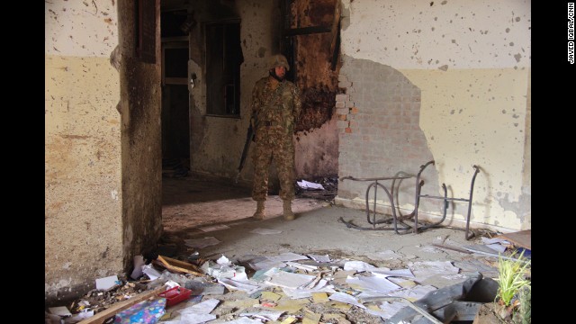 A soldier walks outside the Pakistani school <a href='http://ift.tt/132vqeB'>that was attacked</a> by members of the Pakistani Taliban on Tuesday, December 16. CNN's Nic Robertson took these photos in the aftermath of the attack, which killed more than 140 people.