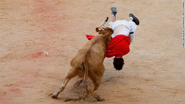 A bull lifts a reveler on July 11. 