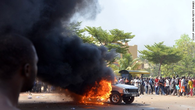 Cars and documents are set ablaze outside parliament on October 30.