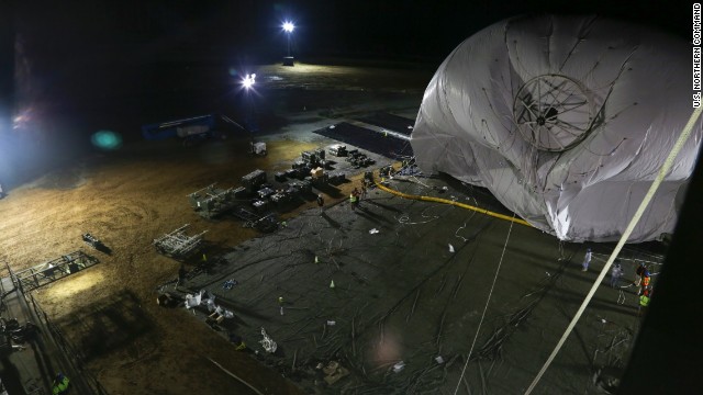 The U.S. Army is launching two stationary "blimps" at 10,000-feet over Maryland to better protect the Washington, D.C., area from cruise missiles and other possible air attacks. On December 14, personnel from the Joint Land Attack Cruise Missile Defense Elevated Netted Sensor System (JLENS) oversee the inflation of an aerostat, or stationary blimp, at Aberdeen Proving Ground, Maryland.
