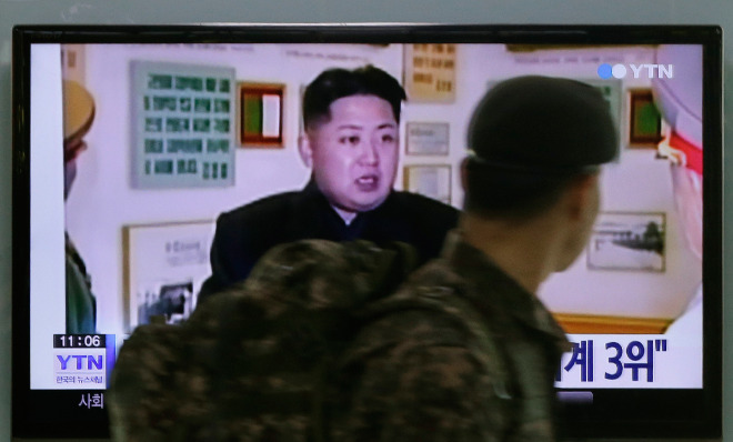 A South Korean army soldier watches a TV news program showing North Korean leader Kim Jong Un at the Seoul Railway Station in Seoul, South Korea, Monday, Dec. 22, 2014. 