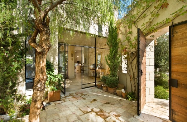 The beautiful entryway is shaded by plenty of greenery, giving it both privacy and vibrance.