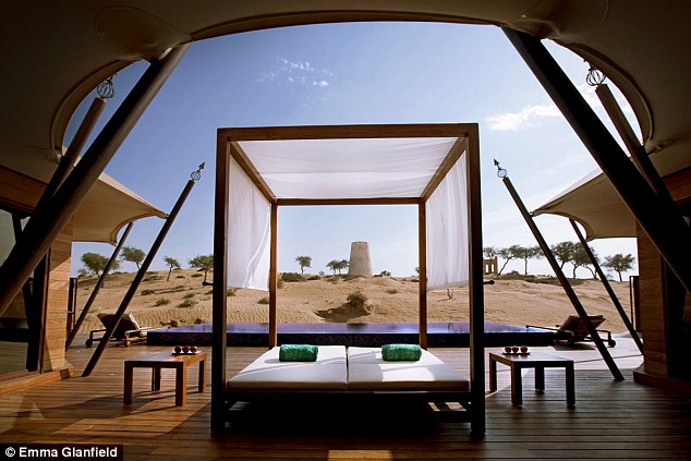 Guests can relax on the four-poster sunbathing loungers which overlook the desert at the Al Wadi complex
