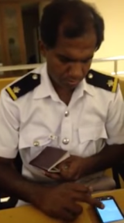 How Emigration - Immigration officer browsers Facebook from phone amidst duties! (video)