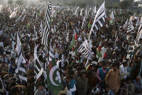 The black-and-white banner of the Jamaat-ud-Dawa, the front group for the Lashkar-e-Taiba, is prevalent at an anti-US rally in Lahore in December 2011. AP photo.