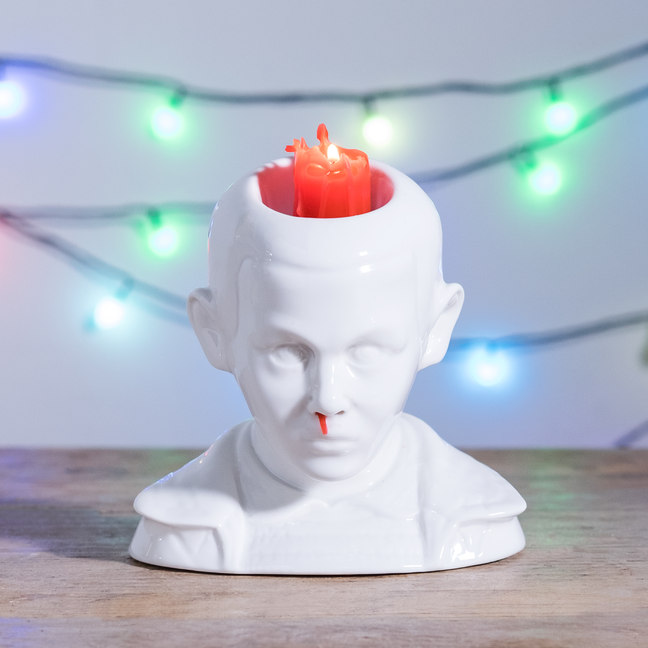 A Stranger Things Eleven candle with a bleeding nose