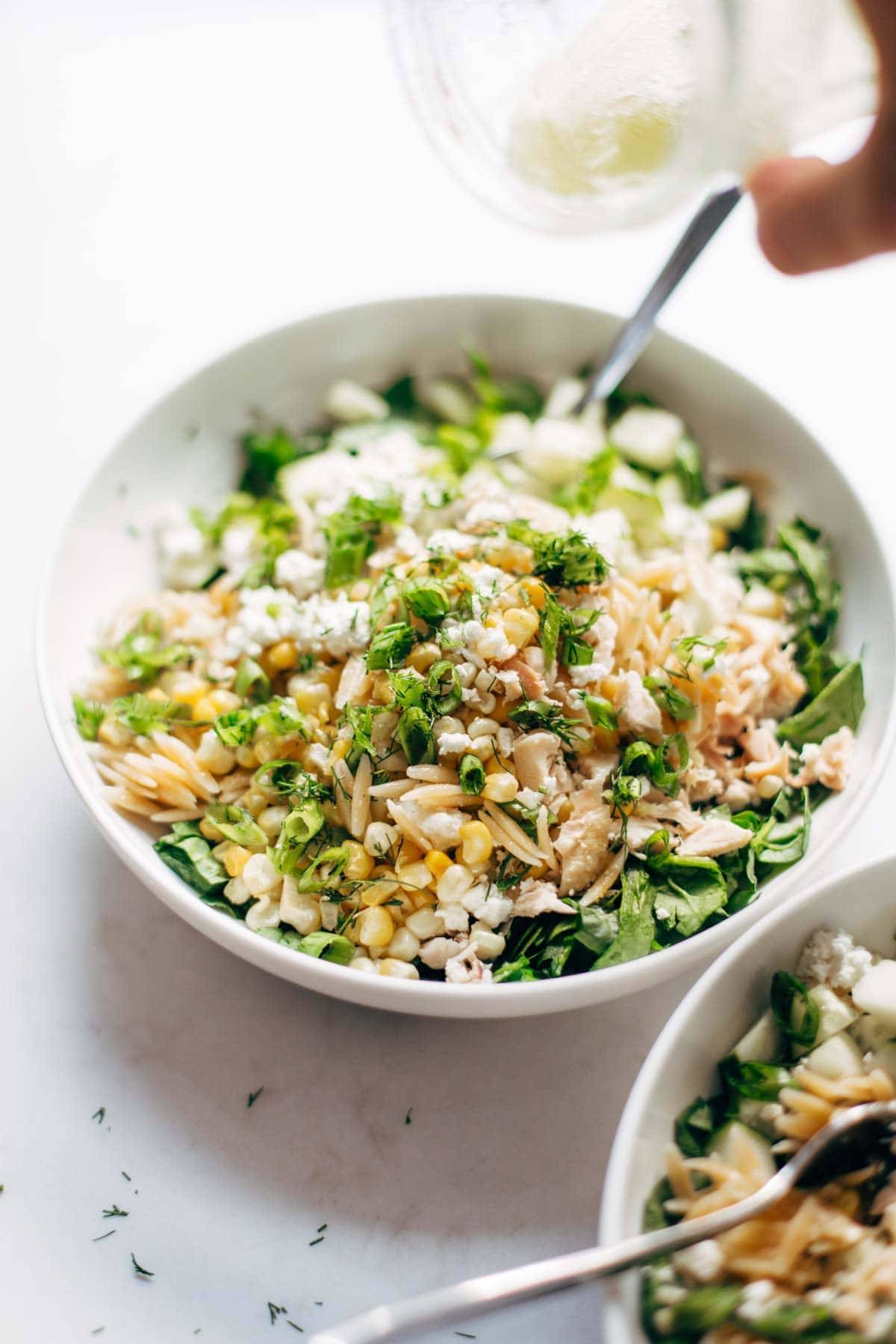 Orzo Summer Salad! With chicken and orzo, loaded with fresh veggies, and finished with a zippy lemon dressing and goat cheese. | pinchofyum.com