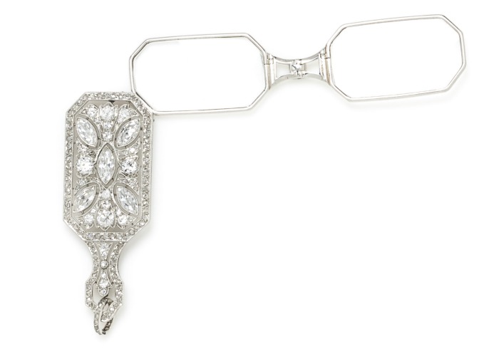 A Fine Art Deco Platinum and Diamond Lorgnette, Charlton & Co.. The glasses fold into the diamond element, which can be worn as a pendant.