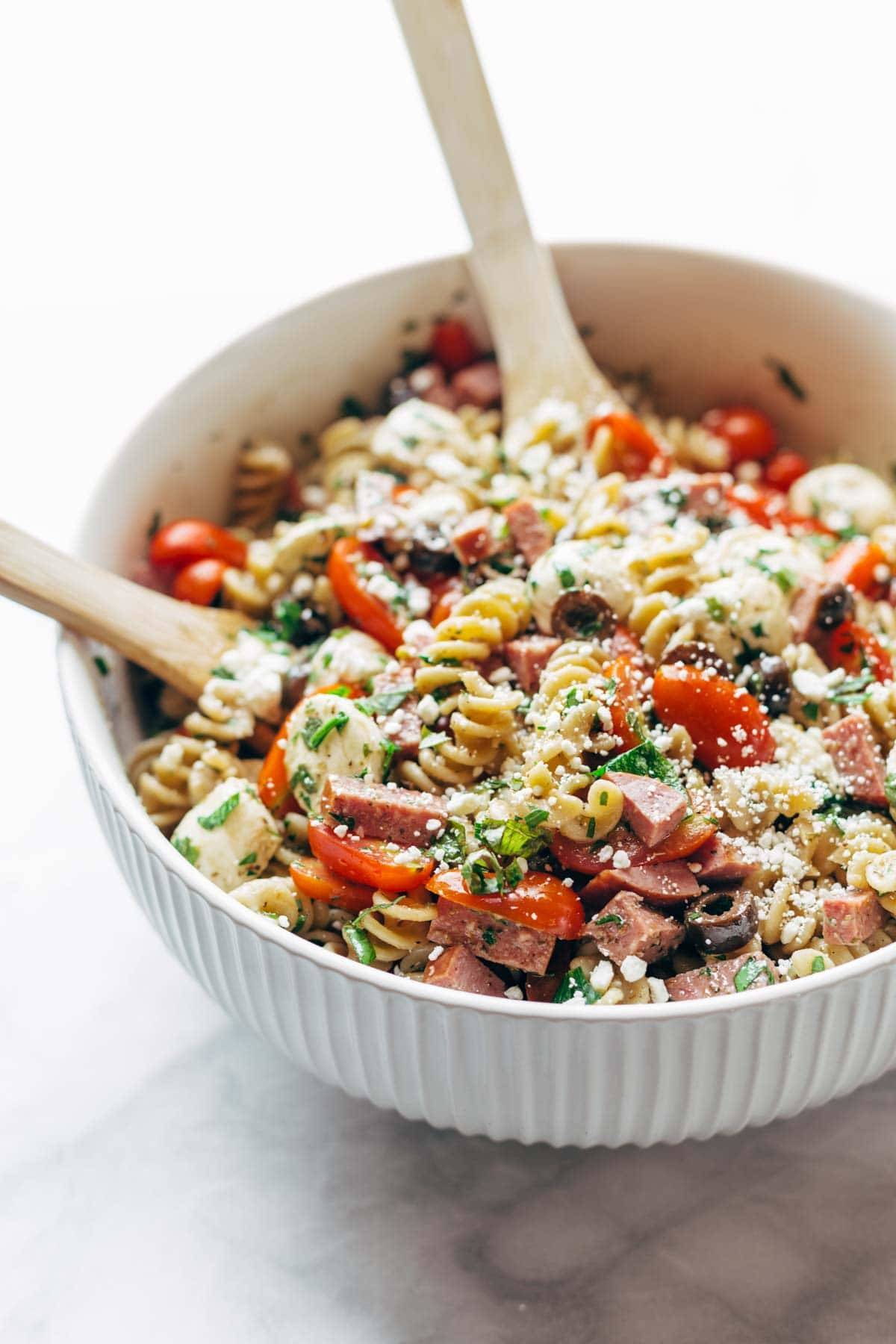 Best Easy Italian Pasta Salad - with pasta, tomatoes, fresh mozzarella, spicy salami, parsley, olives, and easy Italian dressing. Super versatile to what you have on hand! | pinchofyum.comc