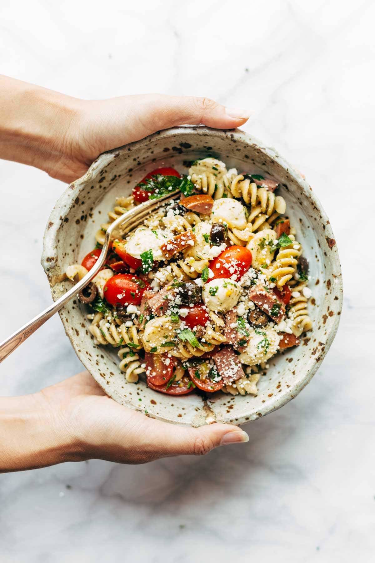 Best Easy Italian Pasta Salad - with pasta, tomatoes, fresh mozzarella, spicy salami, parsley, olives, and easy Italian dressing. Super versatile to what you have on hand! | pinchofyum.comc