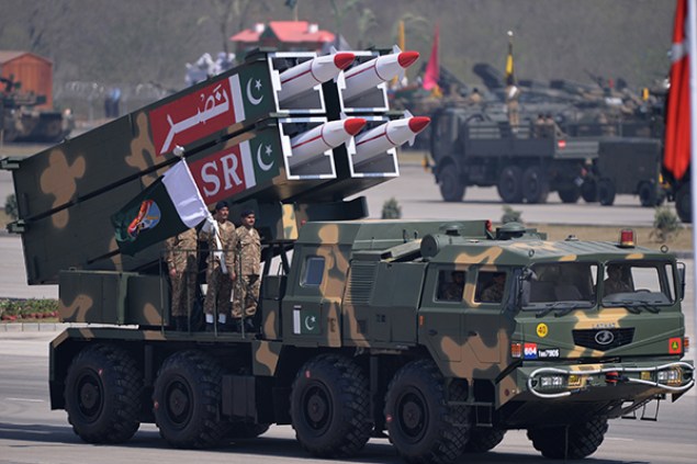 Pakistani military personnel stand beside short-range Surface to Surface Missile NASR during the Pakistan Day military parade in Islamabad on March 23, 2015. Pakistan held its first national day military parade for seven years, a display of pageantry aimed at showing the country has the upper hand in the fight against the Taliban. Mobile phone networks in the capital were disabled to thwart potential bomb attacks, some roads were closed to the public and much of the city was under heavy guard for the event. AFP PHOTO/ Aamir QURESHI