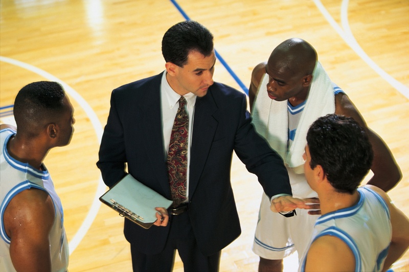 Coach talking to basketball team