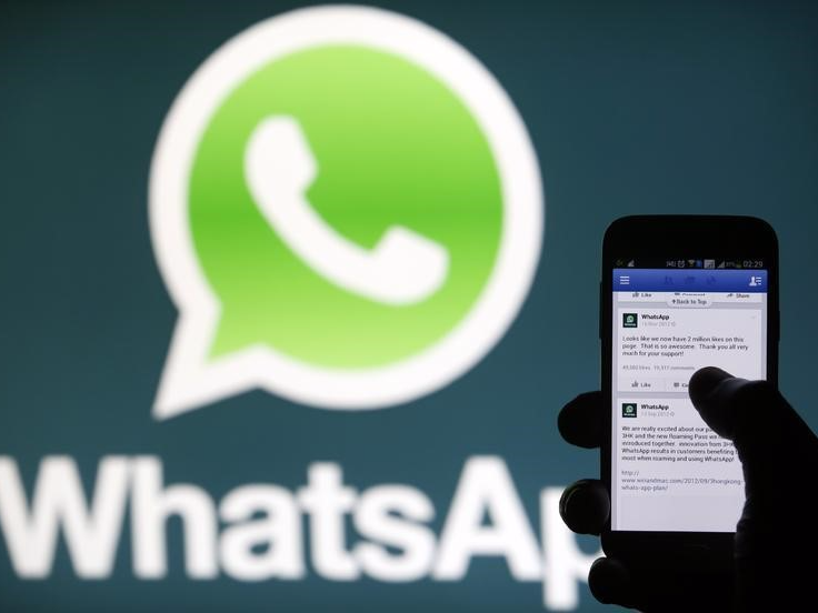 A Whatsapp App logo is seen behind a Samsung Galaxy S4 phone that is logged on to Facebook in the central Bosnian town of Zenica, February 20, 2014. REUTERS/Dado Ruvic 