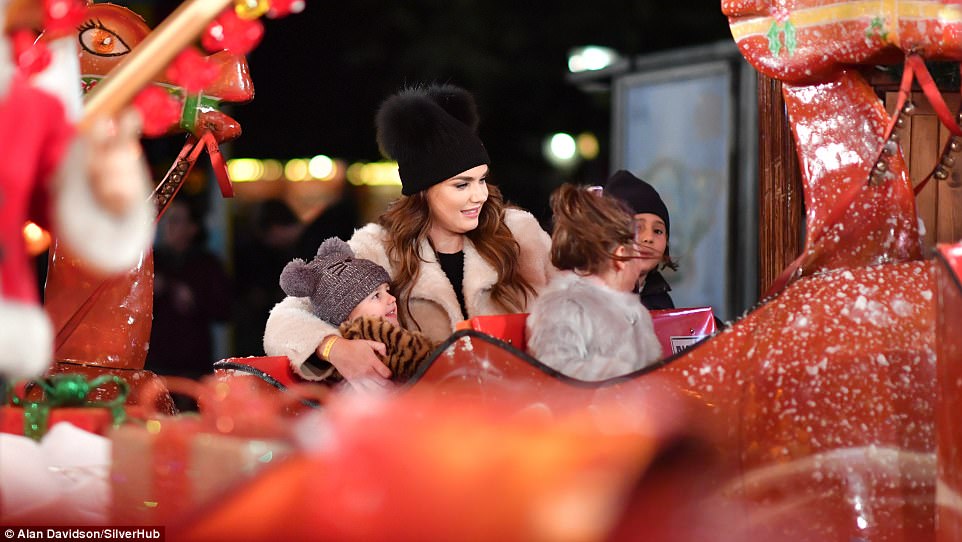 Cute: Sophia cuddled up to her mother as they enjoyed the fairground ride 