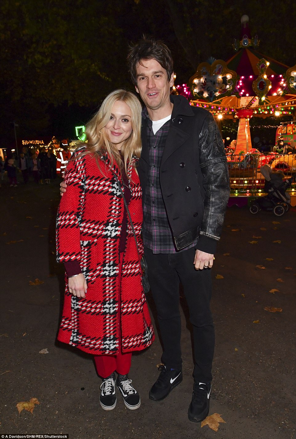 Sweet: The married pair snuggled up to one another at the festive event