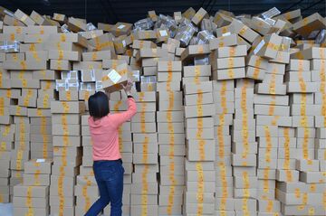 GUANGZHOU, Nov. 11, 2015 -- Workers sort out packages at a sorting center in Guangzhou, capital of south China's Guangdong Province, Nov. 11, 2015. The Singles' Day Shopping Spree, or Double-11 Shopping Spree, Chinese equivalent of Cyber Monday or Black Friday, is an annual online shopping spree falling on Nov. 11 for Chinese consumers since 2009. Each year the express delivery industry will face package peak after the shopping spree. (Xinhua/Liang Xu via Getty Images)