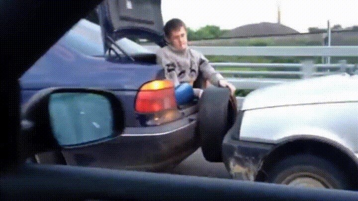 gif of man holding tire as bumper