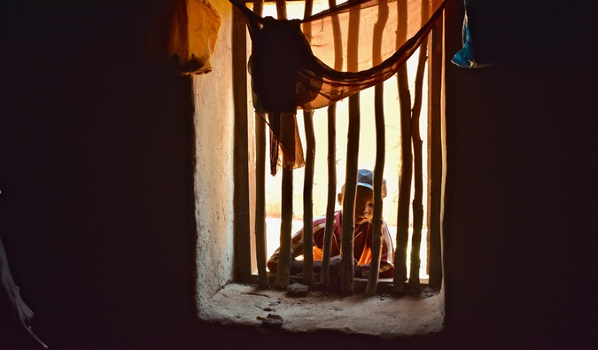 a boy looking through a window in Madagascar