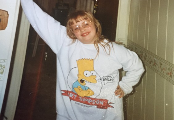 The author, Sierra, as a kid, wearing a pretty fantastic Bart Simpson t-shirt.