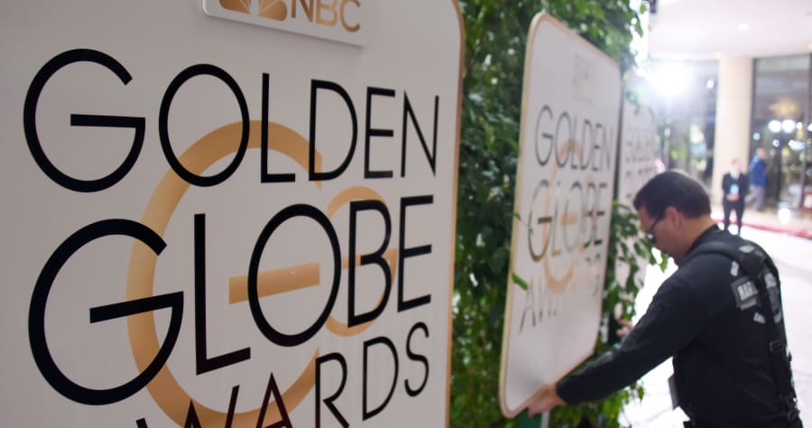 (FILES) This file photo taken on January 9, 2016 shows a worker adjusts signage in the arrivals area for the 73nd annual Golden Globe Awards, at the Beverly Hilton Hotel in Beverly Hills, California.Hollywood's elite hits the red carpet on January 8, 2017 for the 74th Golden Globes, launching a fiercely-contested awards season that looks set to reward escapist fantasy and gritty drama in equal measure. / AFP PHOTO / ROBYN BECK