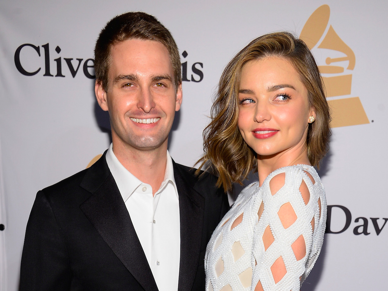 Co-founder and CEO of Snapchat Evan Spiegel (L) and model Miranda Kerr attend the 2016 Pre-GRAMMY Gala and Salute to Industry Icons honoring Irving Azoff at The Beverly Hilton Hotel on February 14, 2016 in Beverly Hills, California. (Photo by )