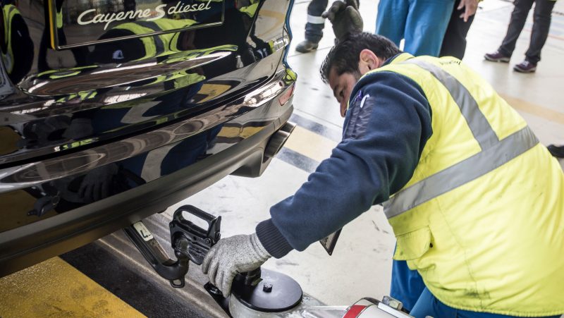 technician attaching a special towbar to the Porsche Cayenne that towed an airbus a380