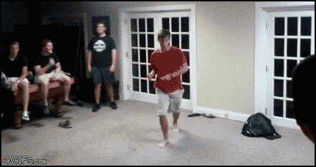 two guys run at each other with exercise balls and one gets launched through a window