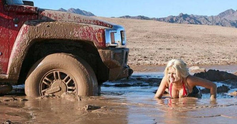 funny photo of a woman in a bikini stuck in mud