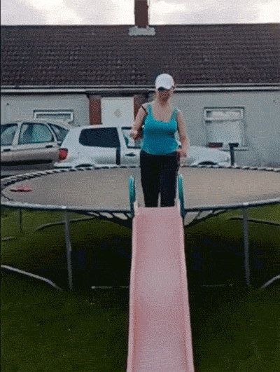 lady jumps and breaks through a children's slide