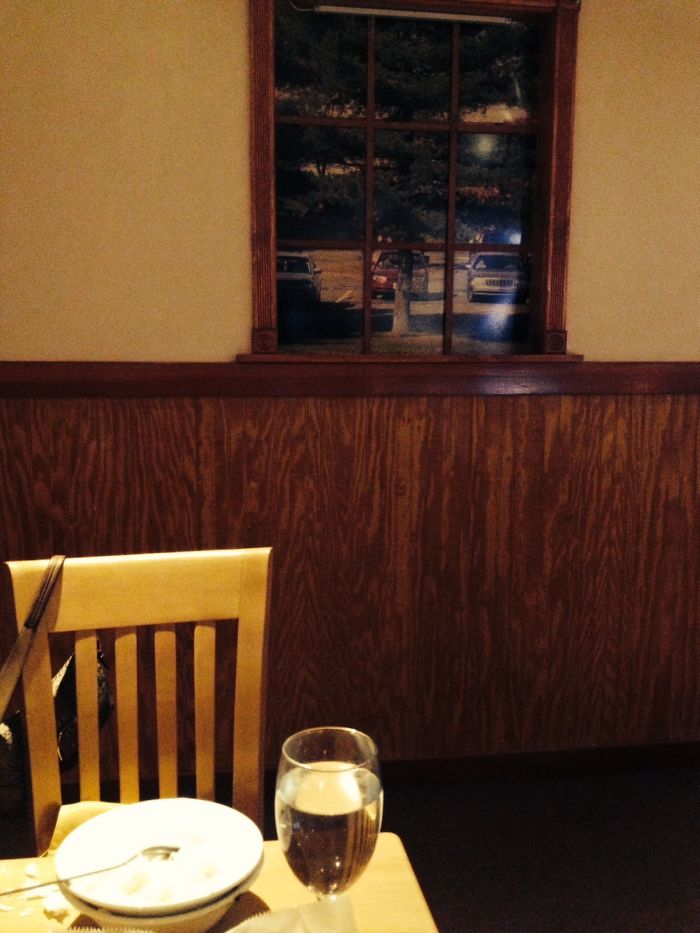 This Indian Restaurant Was In A Basement, But Wanted To Created The Sense That It Wasn't. They Created An Entire Wall Of Fake Windows Looking Out Into Pictures Of A Parking Lot
