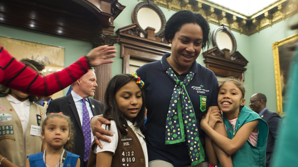 Members of Girl Scout Troop 6000 troop and leader Giselle Burgess hug after being honored as the first troop exclusively for homeless girls, at a ceremony at New York City Hall on April 25.