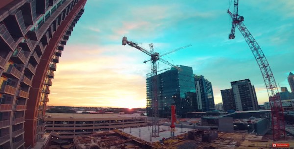 Watch a pro drone racer zip around a construction site at sunset
