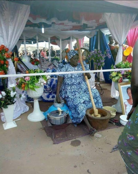 See this shocking photo of a dead woman pounding yam during her burial in Ghana
