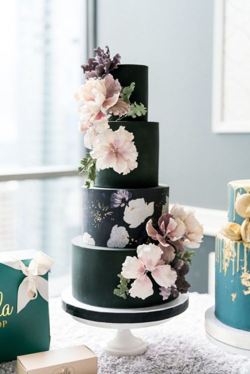 Black wedding cake with pinkish white flowers