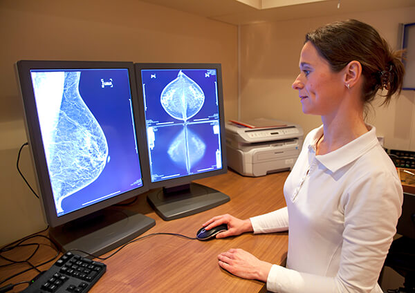 radiology-technician-reviewing-mammograp