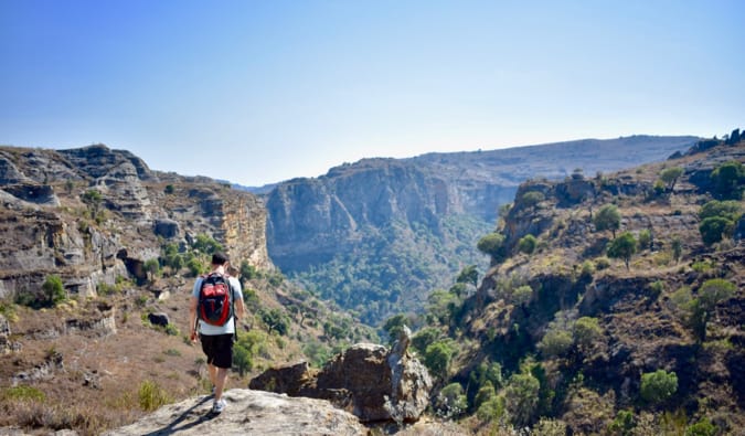 Nomadic Matt hiking near a cliff