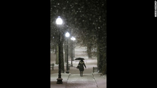 An umbrella comes in handy for a woman on a snow-covered path in Boston Common on January 21.