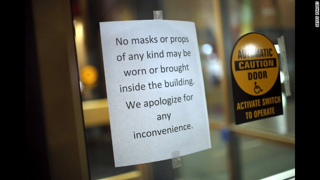 A sign prevents moviegoers from wearing masks or bringing in props to the AMC Arapahoe Crossing 16 movie theater in Aurora.