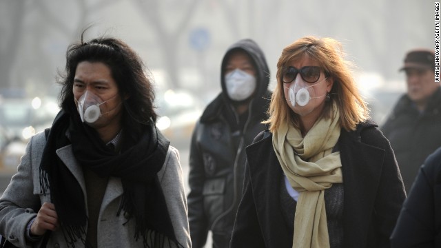 People use face masks during their commute in Beijing on January 16. The Chinese government is trying to control the number of new vehicle registrations this year in some cities to help improve air quality, CNNMoney reports.