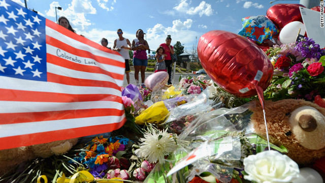 Tiffany Garcia, right, and her 6-year-old daughter, Angelina Garcia, cry on Saturday, July 21, as they look at a memorial for the victims of Friday's shooting. 