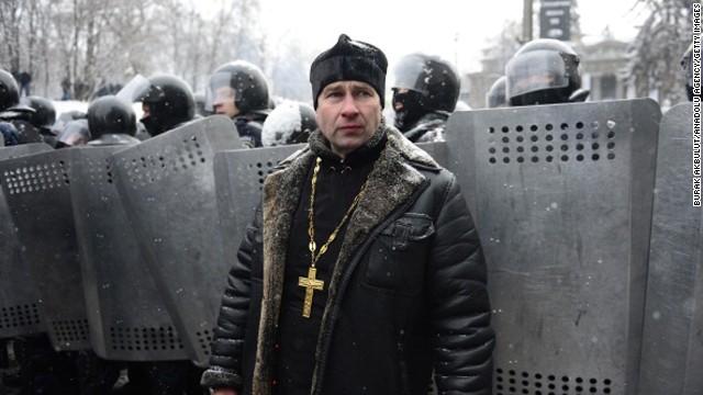 A Ukrainian man stands in front of riot police on January 22.