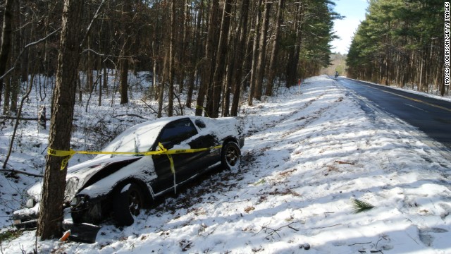 Caution tape is wrapped around a car that crashed into a tree after the driver lost control in Snellville, Georgia, on January 29. 