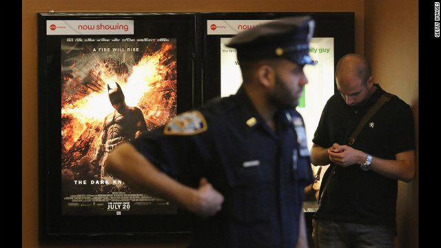 An NYPD officer keeps watch inside an AMC move theater where the film "The Dark Knight Rises" is playing in Times Square on Friday. NYPD is maintaining security around city movie theaters following the deadly rampage in Aurora, Colorado.
