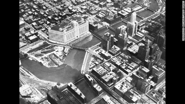 An aerial view of Chicago, circa 1930. The large white building on the Chicago River is the Merchandise Mart, with 4 million square feet of floor space spanning two city blocks and rising 25 stories. It was the largest commercial building in the world when it opened in 1930. 