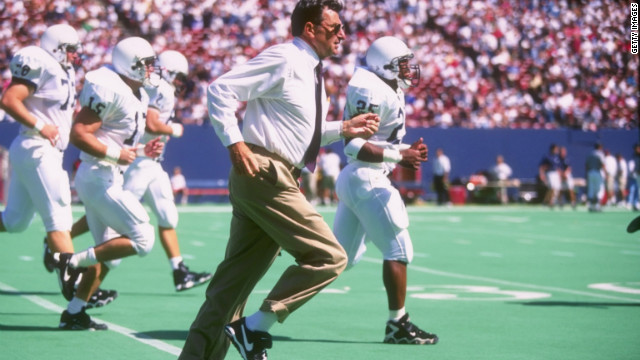 Paterno sprints off the field with his team at halftime in a 1996 game.